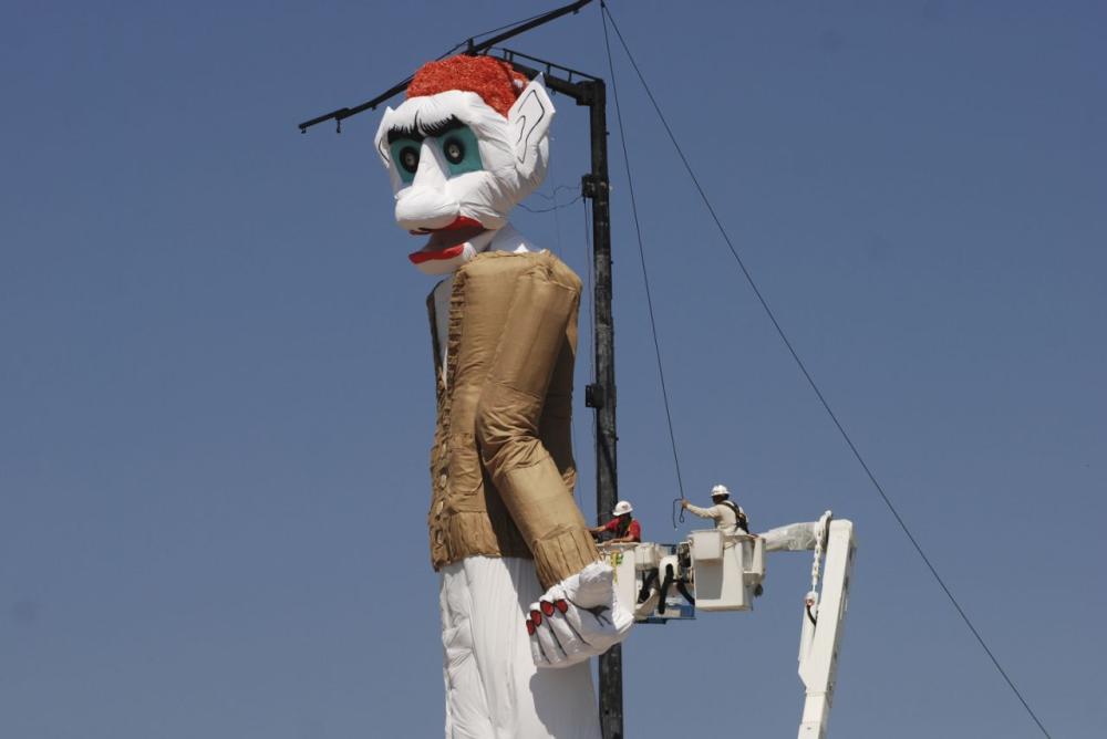 Workers prepare the towering Zozobra marionette for its annual burning at a city park in Santa Fe, New Mexico on Saturday. - AP
