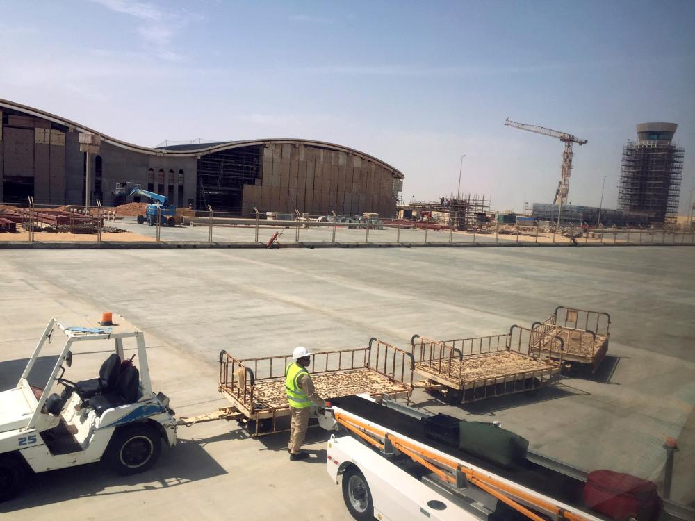 A worker unloads bags at the under-construction Duqm International Airport in Duqm, Oman, on August 21, 2017.  — Reuters