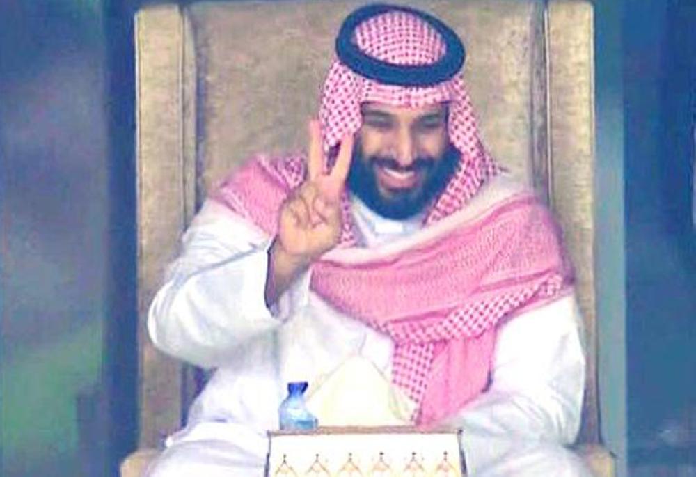 Crown Prince Muhammad Bin Salman, deputy premier and minister of defense, shows victory sign at the end of the World Cup qualifier match at King Abdullah Sports City Stadium in Jeddah on Tuesday night 