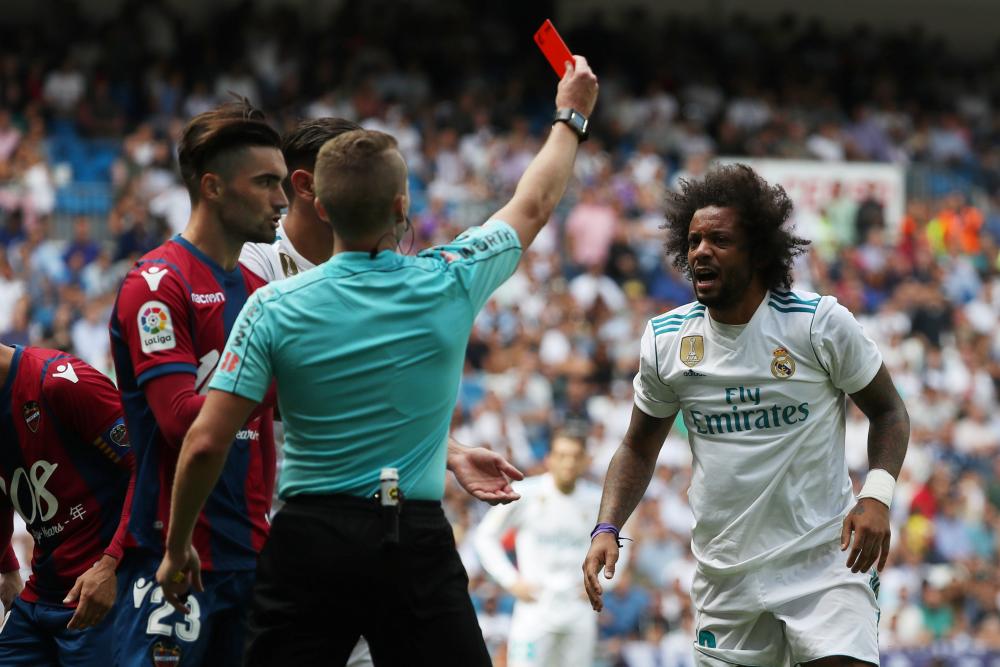 Real Madrid’s Marcelo is shown a red card by referee Alejandro Jose Hernandez during a Spanish league match against Levante in Madrid Saturday. — Reuters