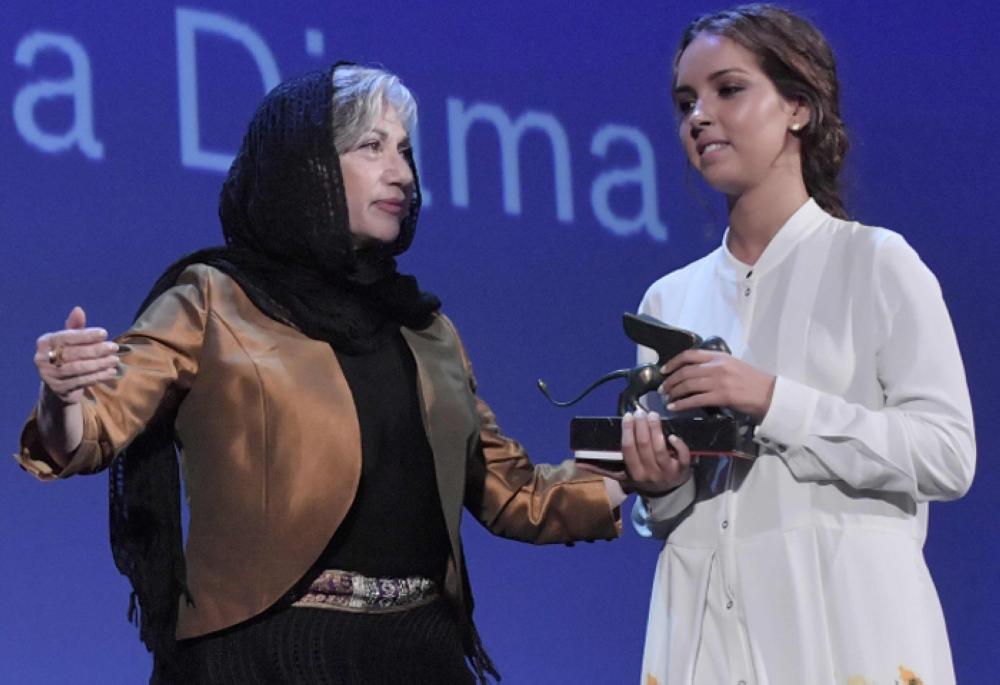 Actress Lina Khoudri, right, receives the Orizzonti Award for Best Actress for her character in the movie 