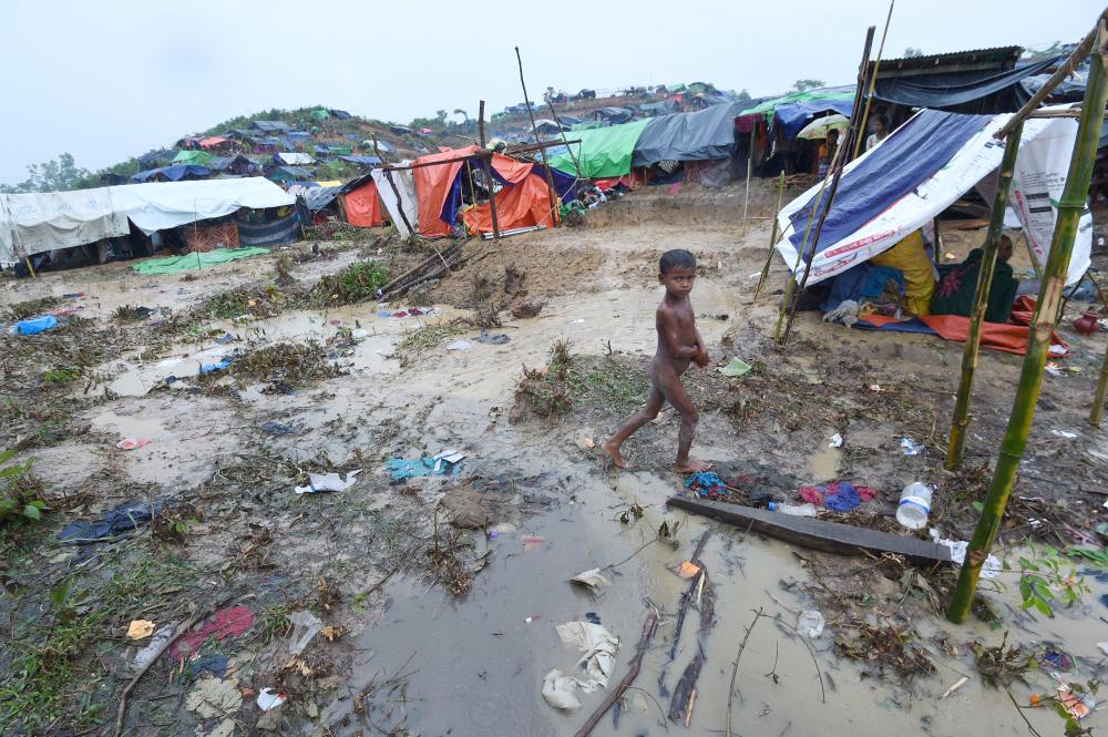 A Rohingya Muslim refugee child walks through Balukhali refugee camp near the Bangladesh town of Gumdhum on Sunday. — AFP