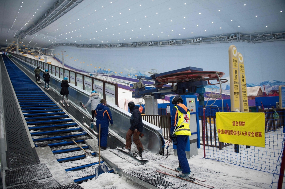 People use a snow escalator at the Wanda Harbin Ice and Snow Park in Harbin, China, in this Aug. 22, 2017 file photo. — AFP