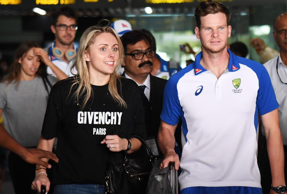 Australian cricket captain Steve Smith (R) and his wife leave the Netaji Subhas Chandra Bose International Airport after arriving ahead of the one day international(ODI) cricket match in the India-Australia series in Kolkata on Monday. — AFP