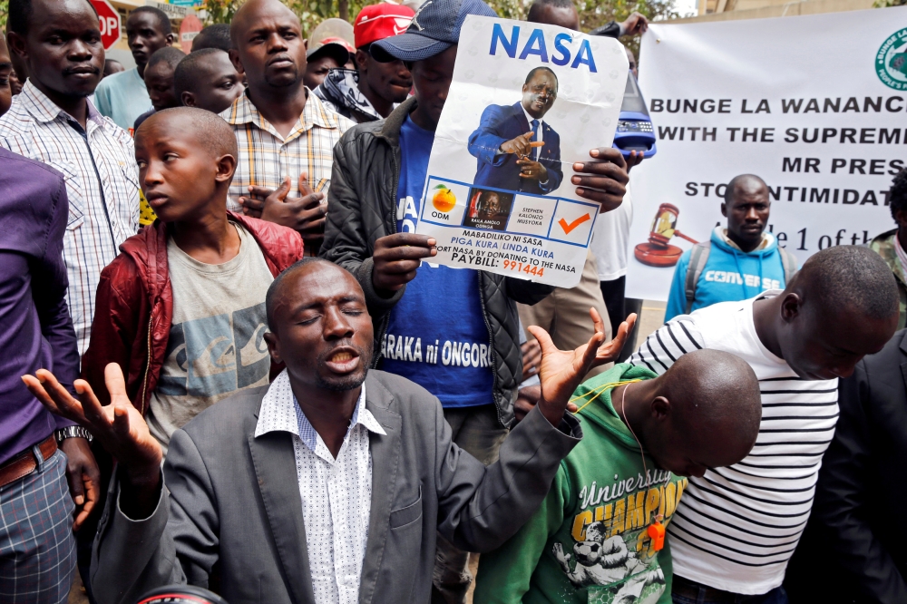 National Super Alliance (NASA) coalition supporters pray near Kenya’s Supreme Court in Nairobi, Kenya, on Wednesday. — Reuters