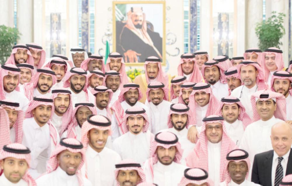 King receives football officials, players