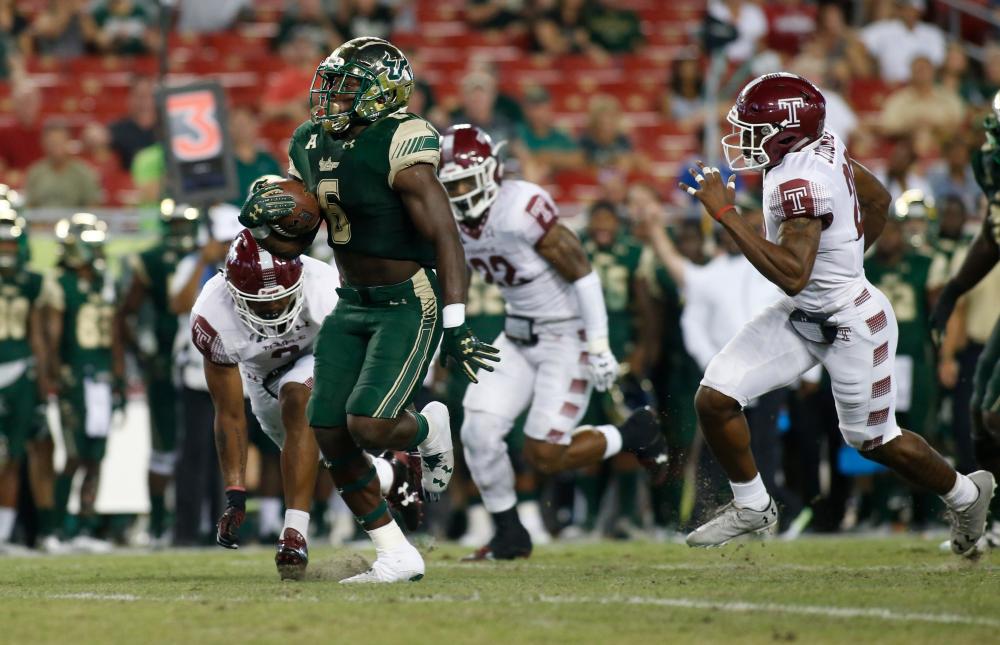 Running back Darius Tice of the South Florida Bulls runs 47 yards for a touchdown during the second quarter of an NCAA football game against the Temple Owls at Raymond James Stadium in Tampa, Florida, Thursday. — AFP