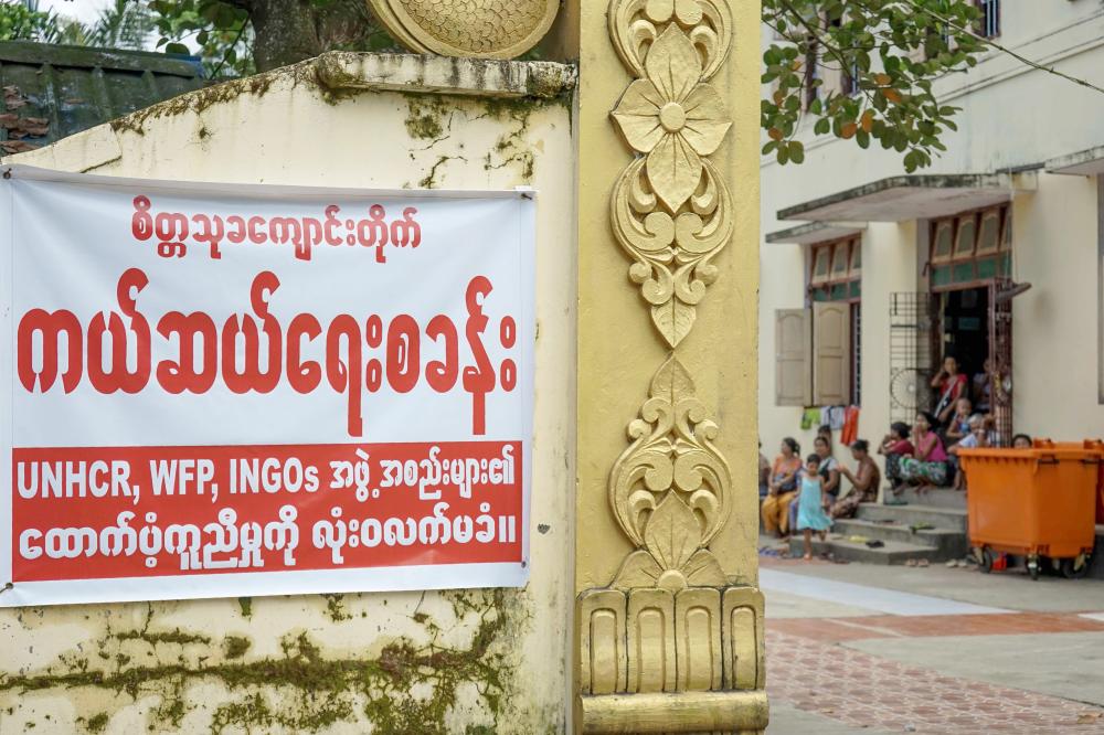 A sign outside a Buddhist temple sheltering scores of ethnic Rakhine IDPs who have fled violence informs that they will not accept aid from the UNHCR, WFP or INGOs in Sittwe, in Myanmar’s Rakhine State on Friday. — AFP