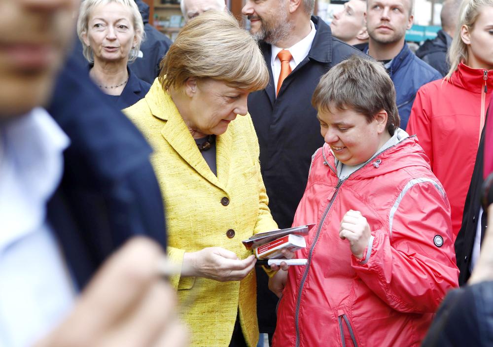 German Chancellor Angela Merkel speaks to a woman during the final Christian Democratic Union (CDU) party campaign in Stralsund, Germany, on Saturday. — Reuters