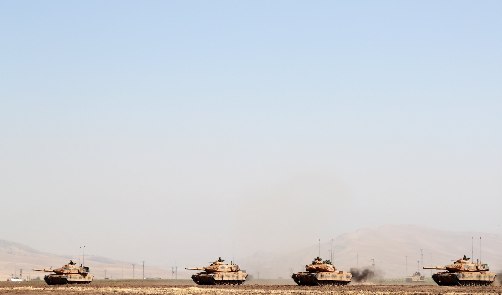 Turkish tanks maneuver during a military exercise near the Turkish-Iraqi border in Silopi, Turkey, on Saturday. — Reuters