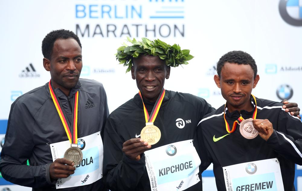 Kenya’s Gladys Cherono, who won the women’s Berlin Marathon race poses with second placed Ethiopia’s Ruti Aga and third placed Kenya’s Valary Jemeli Aiyabei in Berlin Sunday. — Reuters