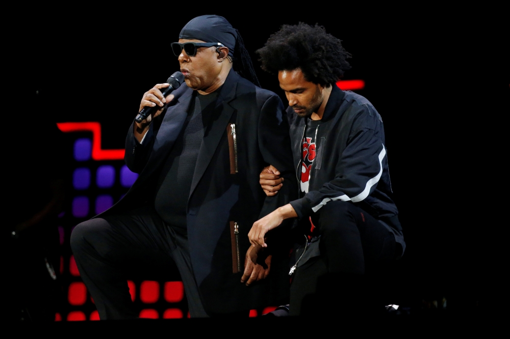 Stevie Wonder takes a knee with his son Kwame Wonder before performing at the 2017 Global Citizens Festival at Central Park in New York on Sunday. - Reuters