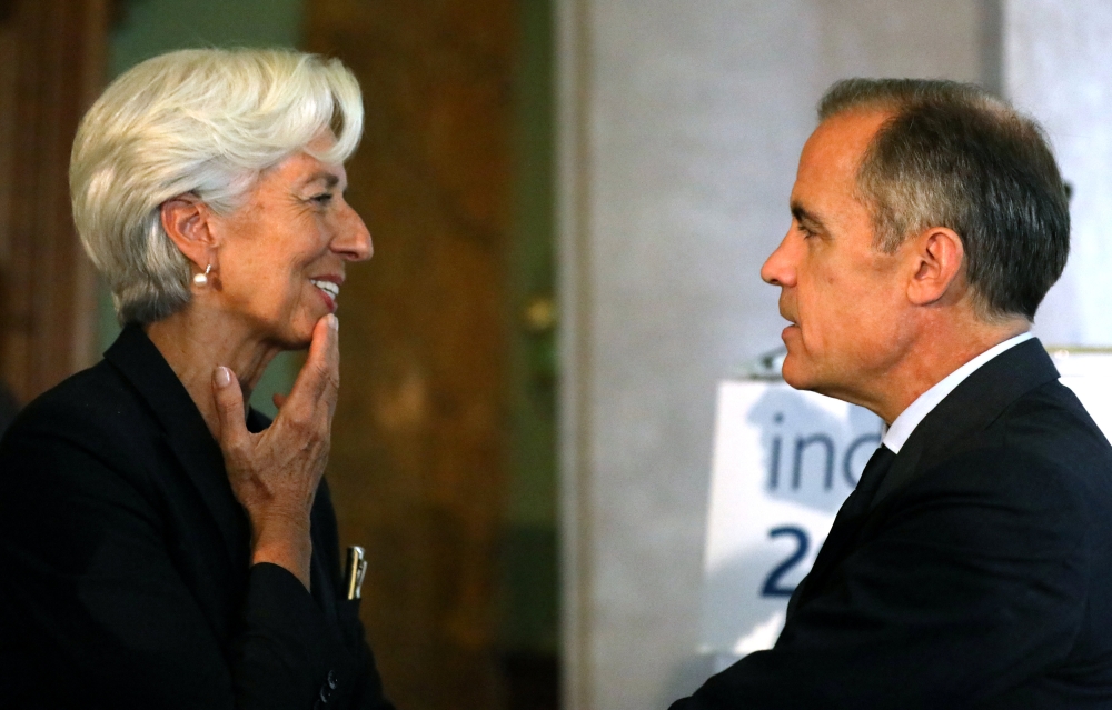 Managing Director of the International Monetary Fund, Christine Lagarde, speaks to the Governor of the Bank of England, Mark Carney, at the Bank of England conference 'Independence 20 Years On' at the Fishmonger's Hall in London, Britain, on Friday. — Reuters