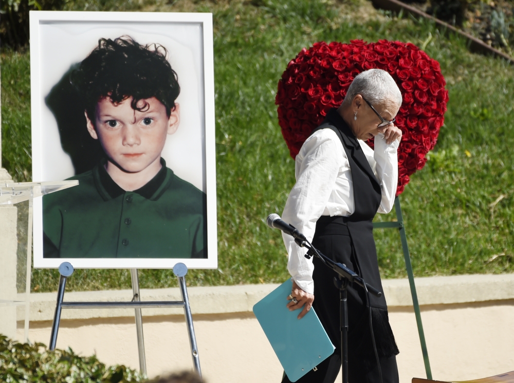 The late actor Anton Yelchin's mother Irina wipes her eyes after speaking at a life celebration and statue unveiling for Yelchin at Hollywood Forever Cemetery on Monday in Los Angeles, California. - AP