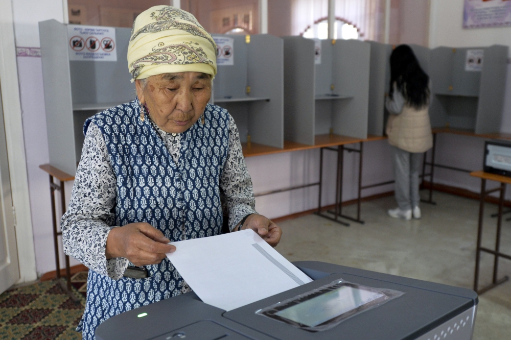 A Kyrgyz woman casts her ballot at a polling station in Bishkek, Kyrgyzstan, on Sunday. — AP