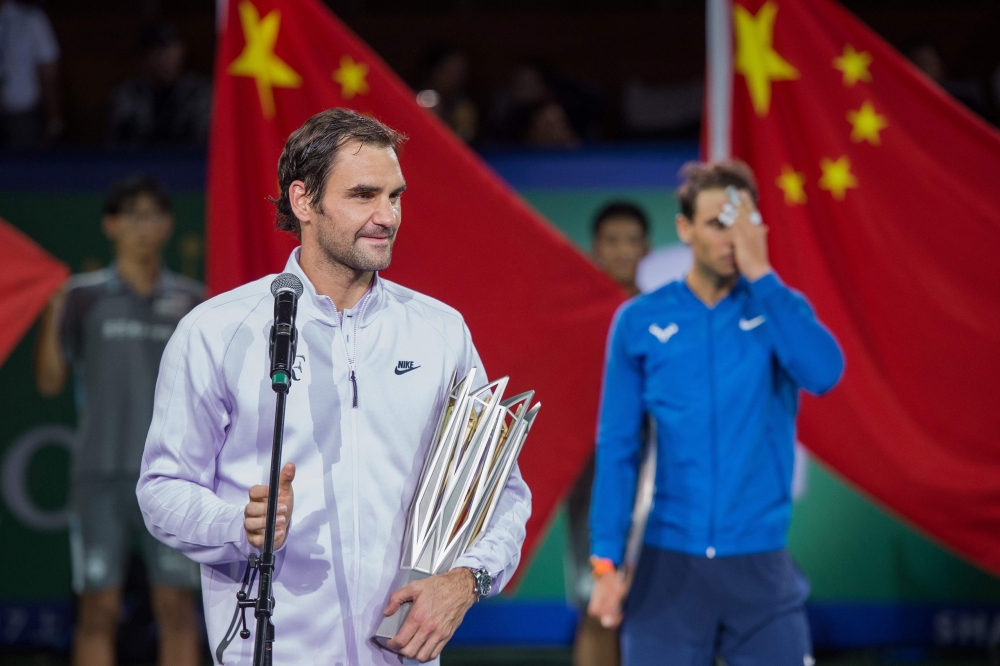 Winner Roger Federer of Switzerland (L) speaks in front of second-placed Rafael Nadal of Spain after the men's singles final match at the Shanghai Masters tennis tournament in Shanghai on Sunday. — AFP