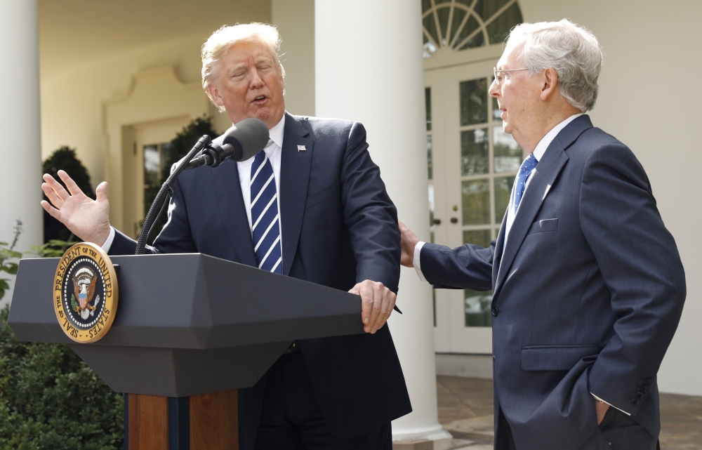US President Donald Trump speaks to the media with US Senate Majority Leader Mitch McConnell at his side in the Rose Garden of the White House in Washington on Monday. — Reuters