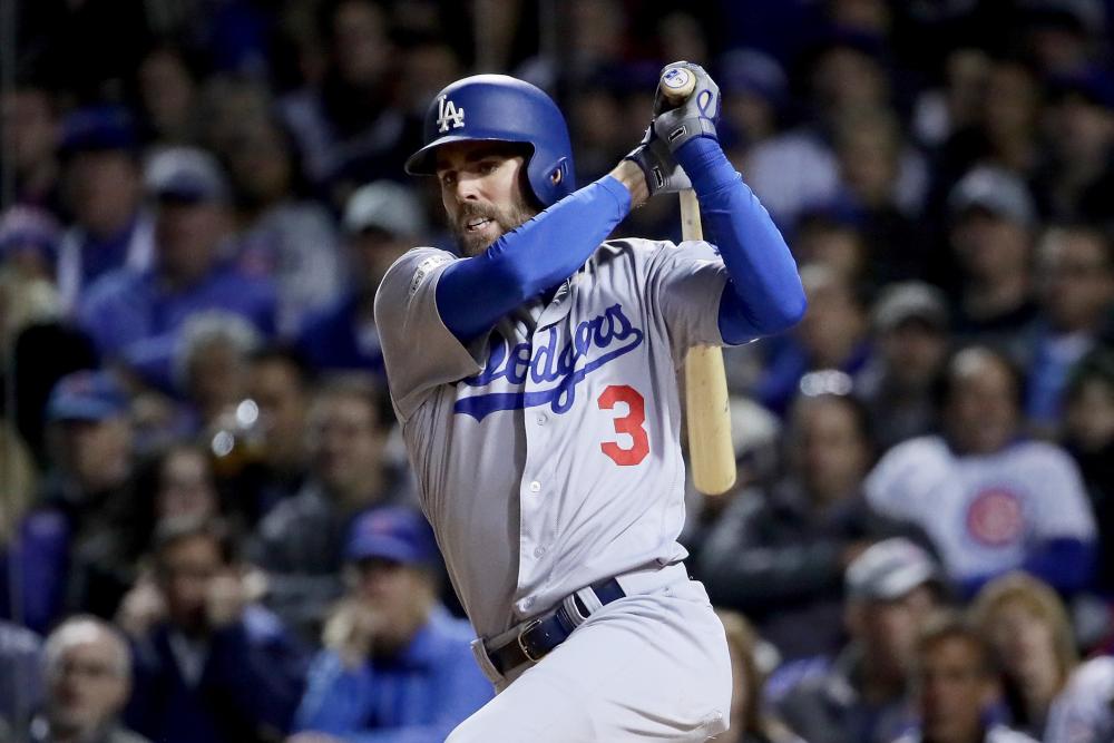 Chris Taylor of the Los Angeles Dodgers hits a triple in the fifth inning against the Chicago Cubs during Game 3 of the National League Championship Series at Wrigley Field in Chicago Tuesday. — AFP 