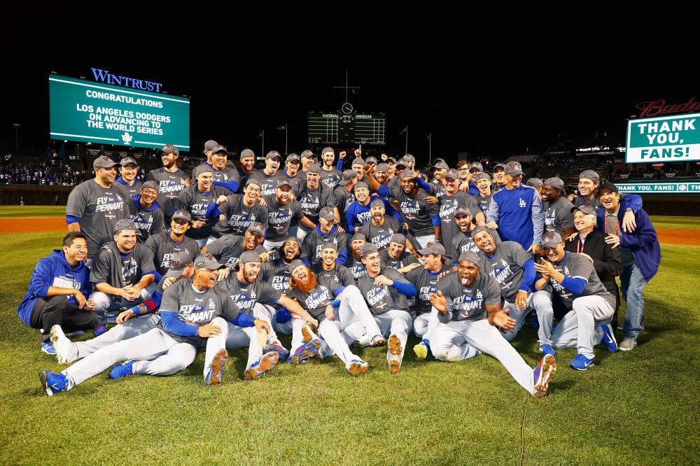 The Los Angeles Dodgers pose after defeating the Chicago Cubs in Game 5 of the National League Championship Series at Wrigley Field in Chicago Thursday. — AP