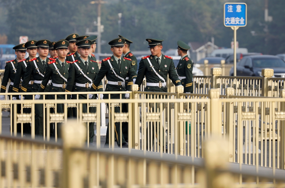 Paramilitary policemen patrol at the Tiananmen Gate during the 19th National Congress of the Communist Party of China at the Tiananmen Gate in Beijing, Friday. — Reuters