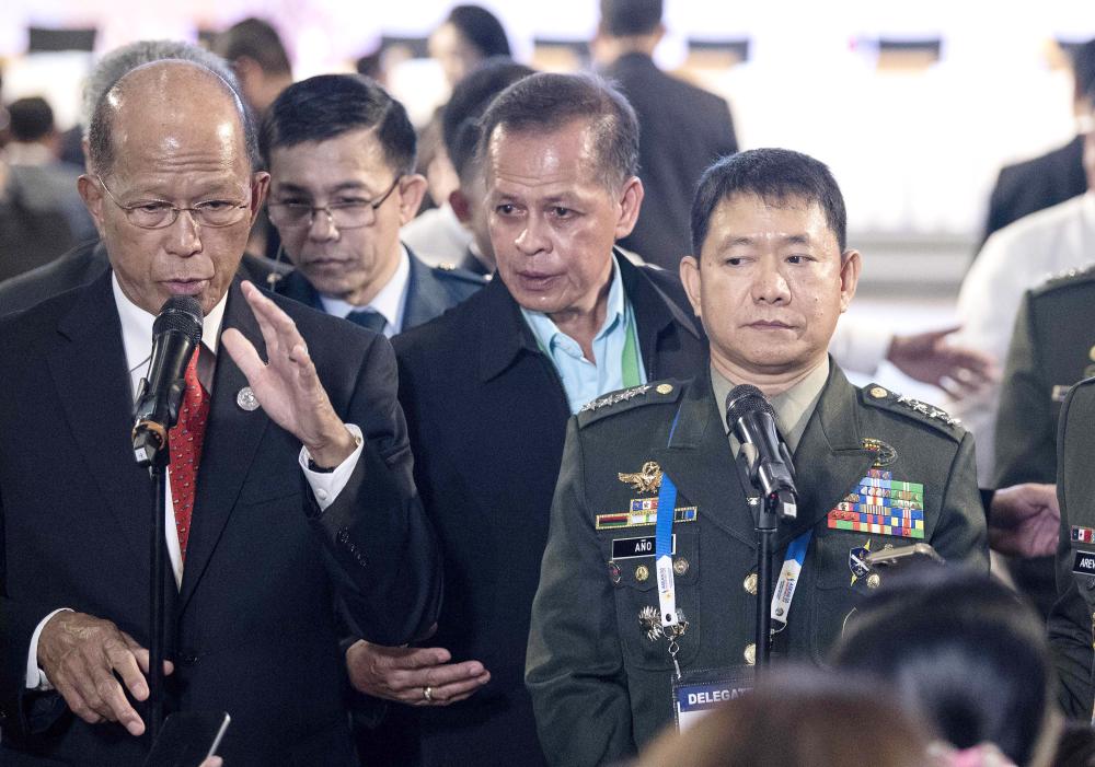 Philippines Defence Secretary Delfin Lorenzana (L) with Armed Forces of the Philippines (AFP) chief Eduardo Ano (R), answers questions during a press conference in Clark, east of Manila on Monday. — AFP