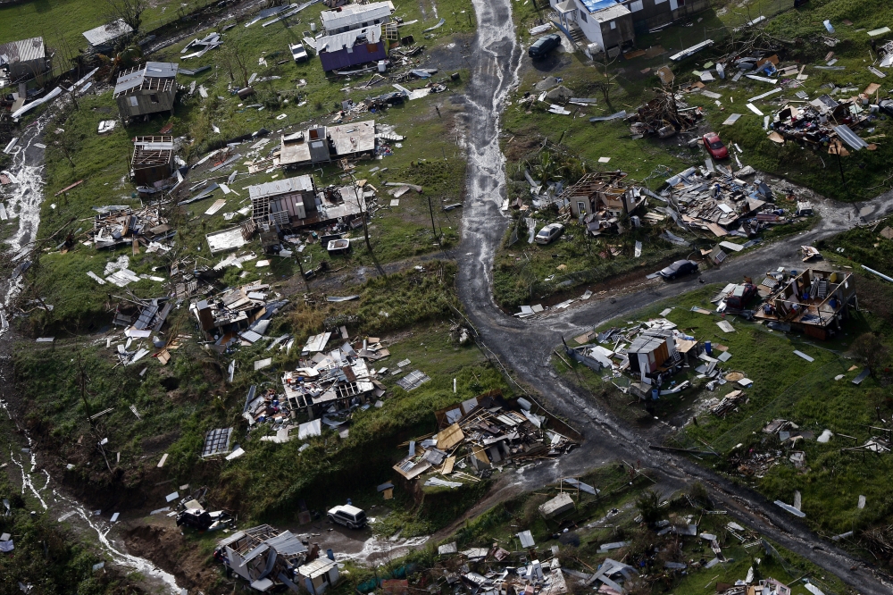 In this file photo, debris scatters a destroyed community in the aftermath of Hurricane Maria in Toa Alta, Puerto Rico. The Senate is pushing ahead on a $36.5 billion hurricane relief package that would give Puerto Rico a much-needed infusion of cash but rejects requests from the powerful Texas and Florida congressional delegations for additional money to rebuild after hurricanes Harvey and Irma. — AP