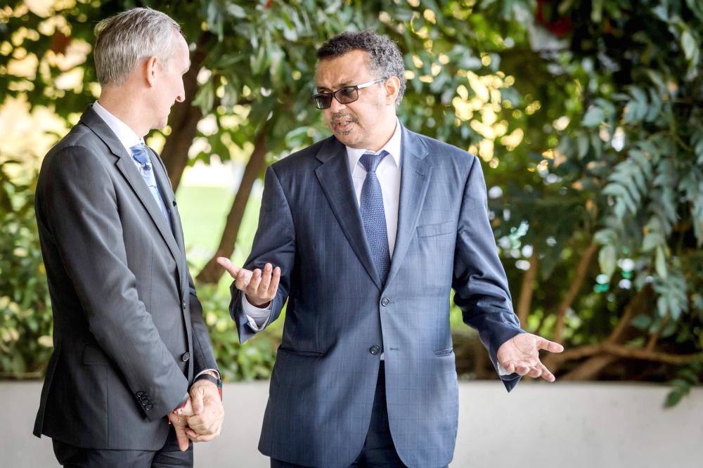 World Health Organization (WHO) Director General Ethiopia's Tedros Adhanom Ghebreyesus (R) gestures prior to an official visit outside the WHO headquarters on Tuesday in Geneva. The head of the WHO had reversed his decision to name Zimbabwe's President Robert Mugabe a goodwill ambassador, saying it was in the 
