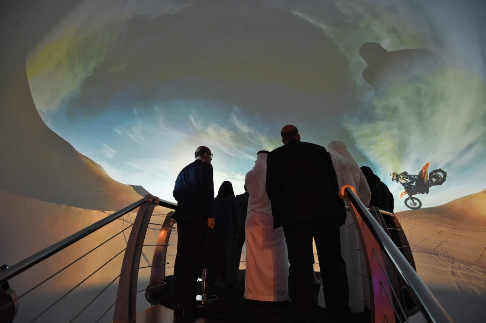 Participants watch a movie advertising Saudi's Red Sea project on the sidelines of the three-day Future Investment Initiatives conference in Riyadh. — AFP