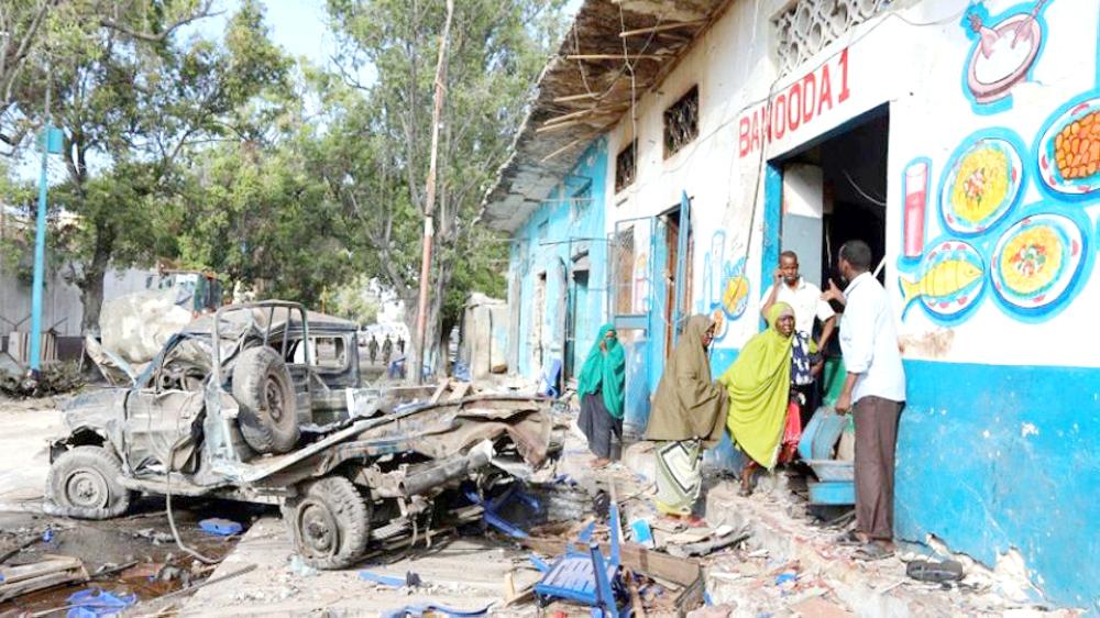 Residents gather at the scene of a suicide car bomb explosion, at the gate of Naso Hablod Two Hotel in Hamarweyne district of Mogadishu, Somalia. — Reuters