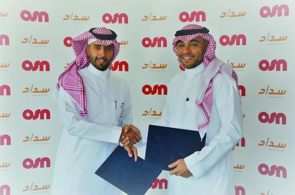 Bandar AlSunbuly of OSN and Ziad AlYousef of SADAD shake hands after the signing of agreement