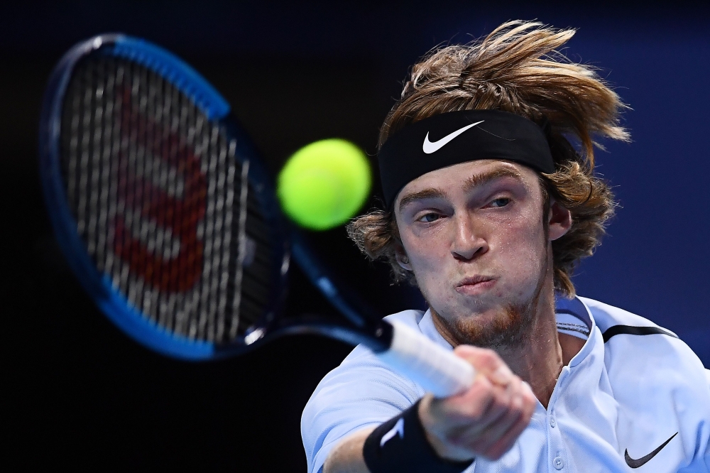 Russia's Andrey Rublev returns a shot to South Korea's Hyeon Chung during their men's singles semi final match of the first edition of the Next Generation ATP Finals in Milan on November 8, 2017, an annual men's youth tennis tournament organized by the Italian Tennis Federation and the Italian Olympic Committee. / AFP / MARCO BERTORELLO
