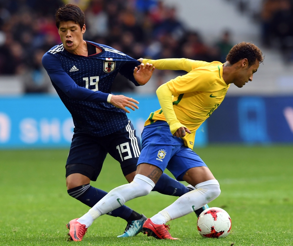 Brazil's forward Neymar (R) vies with Japan's defender Sakai Hiroki (L) during the friendly football match between Japan and Brazil on Friday at the Pierre Mauroy Stadium in Villeneuve d'Ascq, northern France. —  AFP