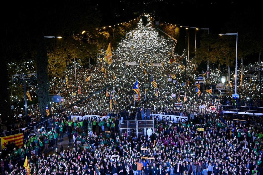 People take part in a demonstration in Barcelona, Spain, on Saturday night. — AFP
