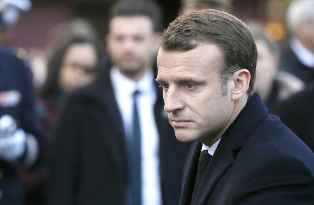 French President Emmanuel Macron gives his condolences to relative of victims in Paris during a ceremony marking the second anniversary of the Paris attacks on Monday. — AP 