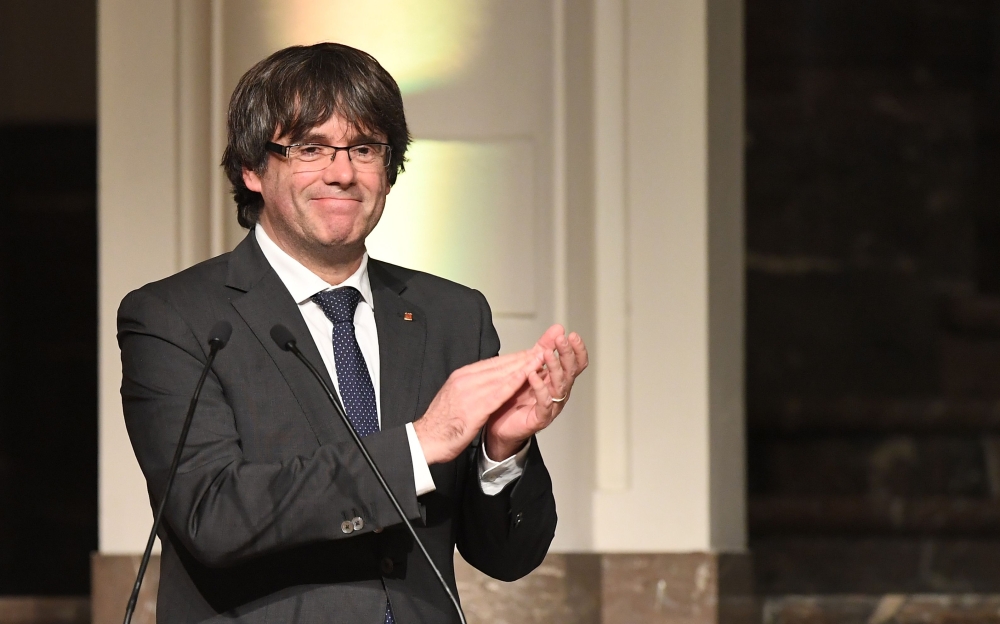 Catalonia’s sacked leader Carles Puigdemont applauds while delivering a speech during a meeting with Catalan mayors in Brussels in this Nov 7, 2017 file photo. — AFP