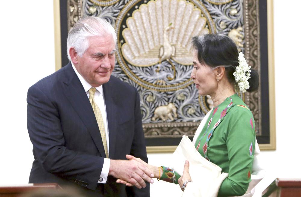 Myanmar’s leader Aung San Suu Kyi, right, shakes hands with visiting US Secretary of State Rex Tillerson after their press conference at the Foreign Ministry office in Naypyitaw, Myanmar, on Wednesday. — AP