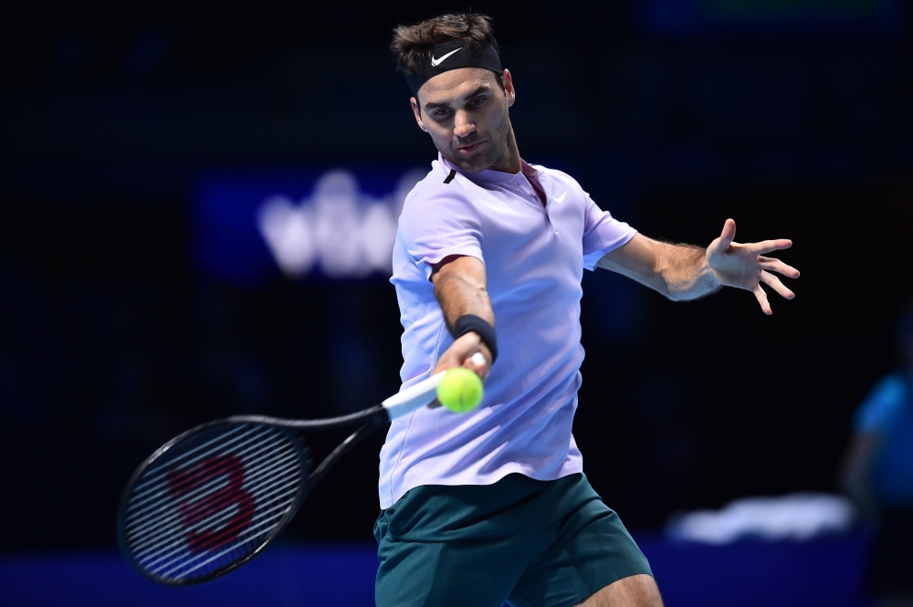 Switzerland's Roger Federer returns against Germany's Alexander Zverev during their men's singles round-robin match on day three of the ATP World Tour Finals tennis tournament at the O2 Arena in London on Tuesday. — AFP