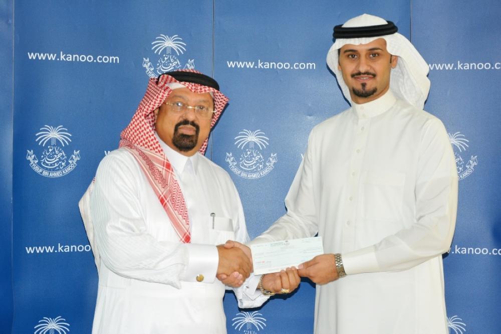 Sultan Al Yazeedi handing over the sponsorship check to Dr. Faiz Al Abideen of JCA.