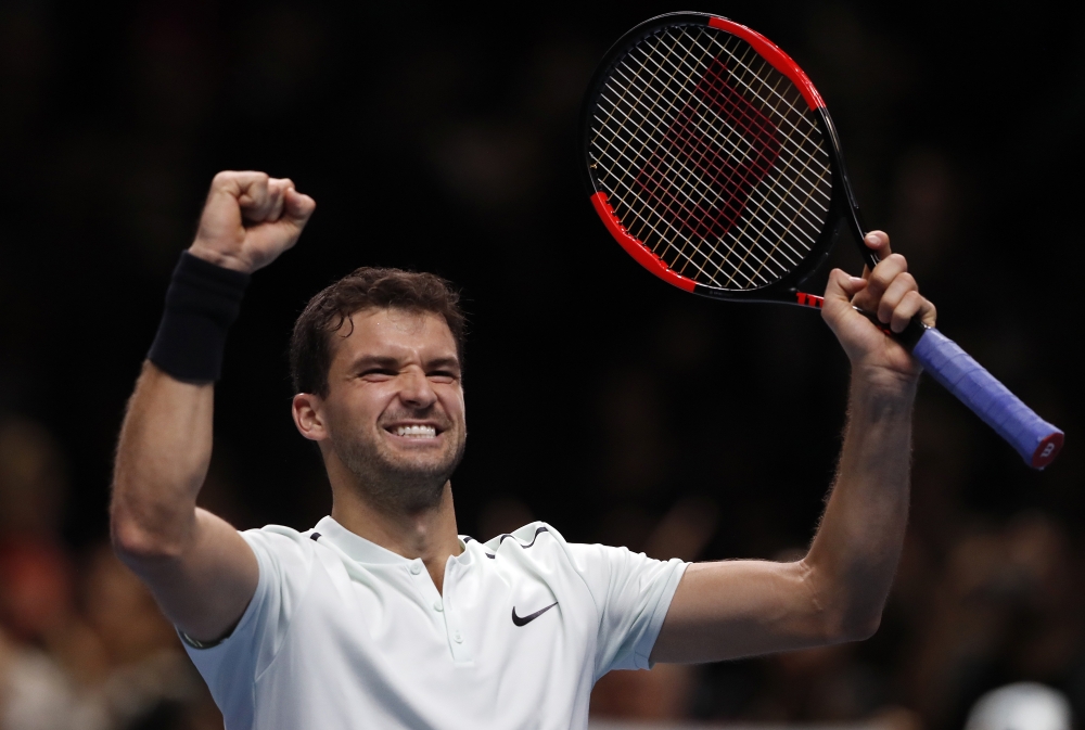 Grigor Dimitrov of Bulgaria celebrates after winning his singles tennis match against David Goffin of Belgium at the ATP World Finals at the O2 Arena in London, Wednesday. — AP