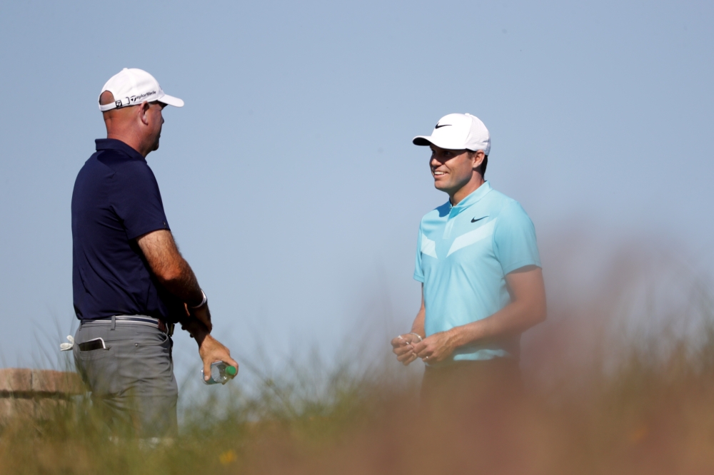 Nick Watney (R) and Stewart Cink (L) of the United States talk on the 15th hole during the first round of The RSM Classic at Sea Island Golf Club Seaside Course on Thursday in St Simons Island, Georgia. — AFP