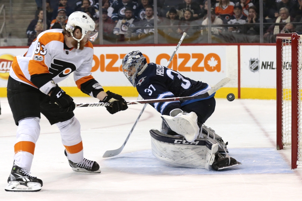 Philadelphia Flyers right wing Jakub Voracek (93) scores in the shoot out against Winnipeg Jets goalie Connor Hellebuyck (37) at Bell MTS Centre. — Reuters