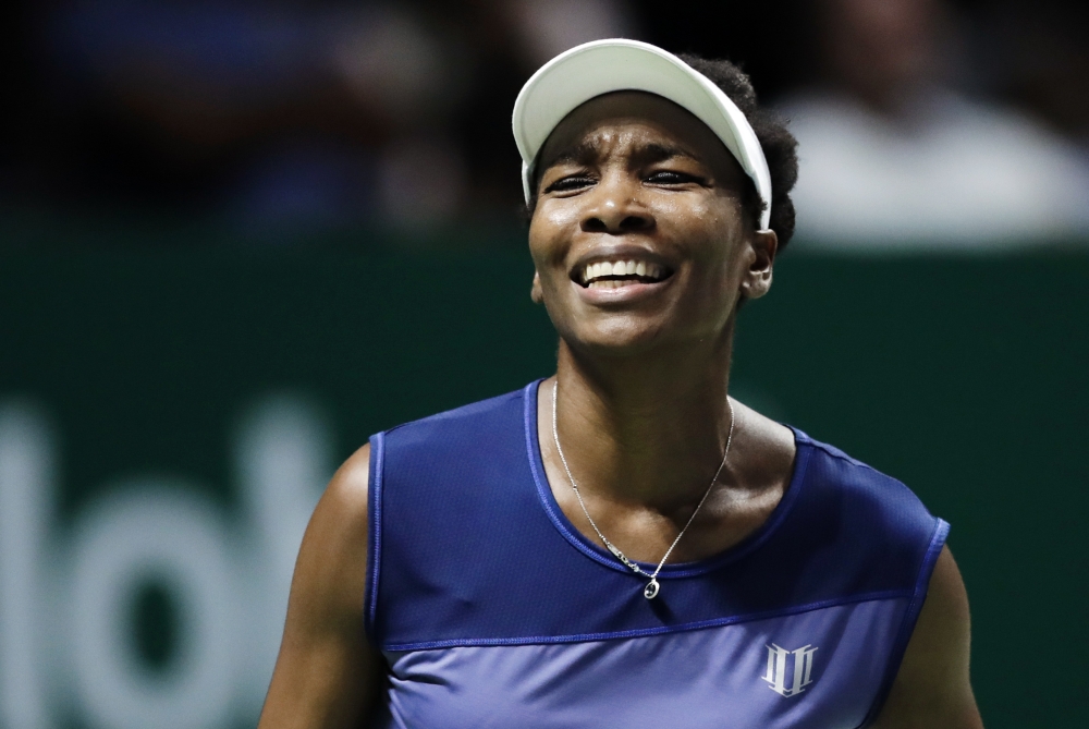 In this file photo, Venus Williams, of the United States, reacts after conceding a point to Caroline Garcia, of France, during their semifinal match at the WTA tennis tournament in Singapore. Burglars hit the tennis star's Florida home, stealing $400,000 worth of goods while she was at the US Open. Palm Beach Gardens police released a report Thursday, about the burglary, which happened between Sept. 1 and 5. — AP