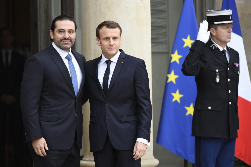 French President Emmanuel Macron (R) welcomes Lebanese Prime Minister Saad Hariri at the Elysee Presidential Palace on Saturday in Paris. —  AFP