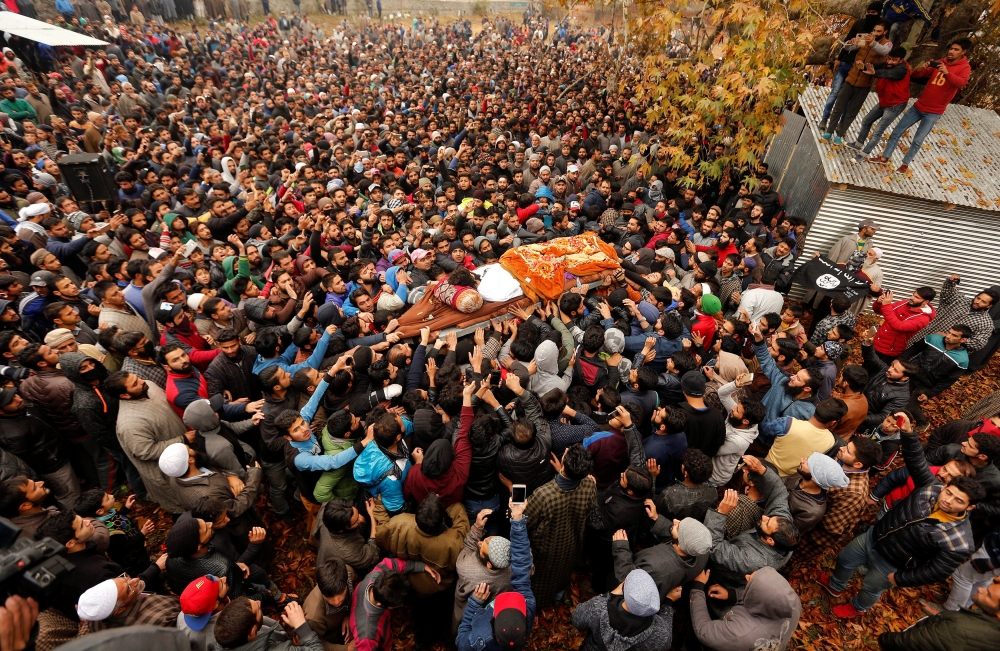 People carry the remains of Mugees Mir, a suspected militant who according to local media was killed in an encounter with the Indian security forces in Zakura, during his funeral in Srinagar, on Saturday. — Reuters