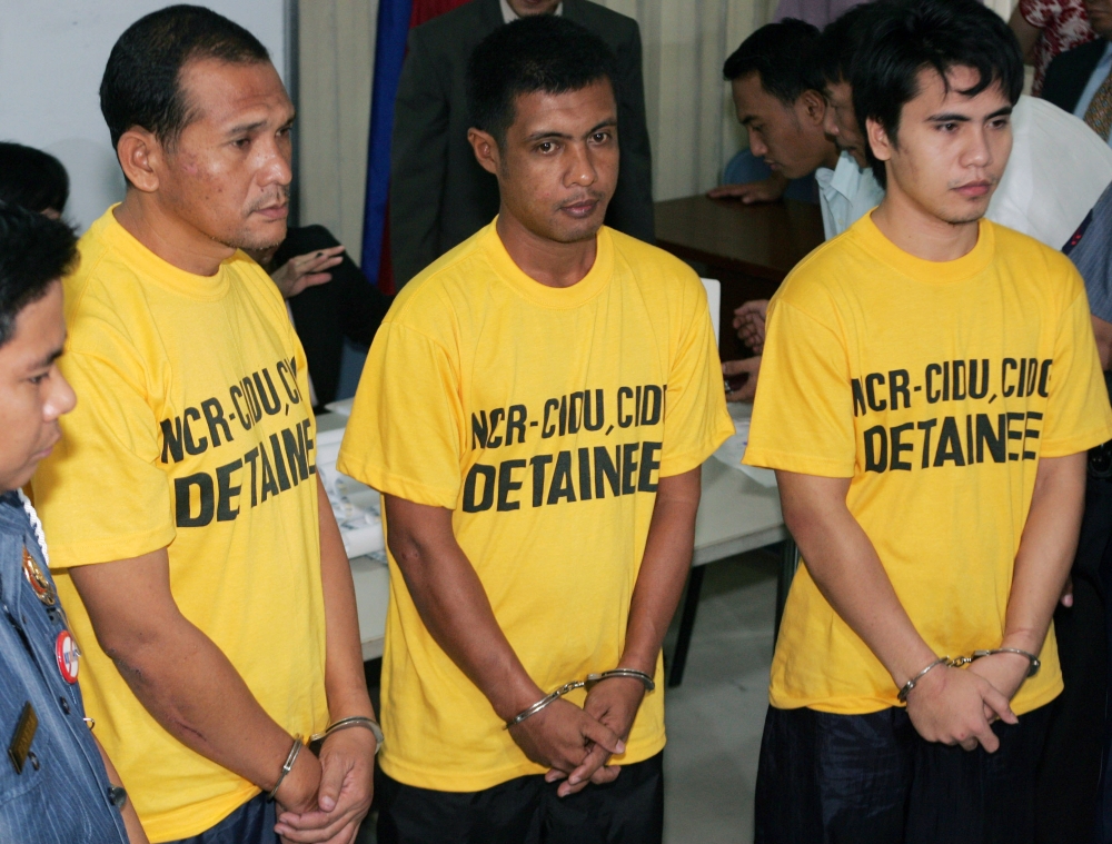 Suspects from right Adnam Kusain, Ikram Indama and Caidar Aunal linked to the blast at the House of Representatives are lined up at the Department of Justice in Manila, Philippines, in this file photo. — AP