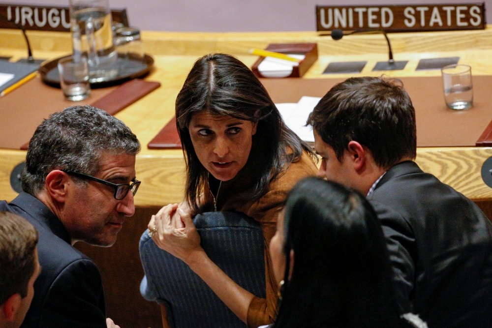 US Ambassador to the United Nations Nikki Haley speaks with a member of her team following a UN Security Council meeting on a bid to renew an international inquiry into chemical weapons attacks in Syria, at the United Nations headquarters in New York. — Reuters