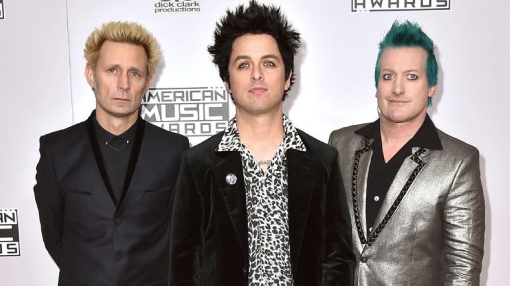 Mike Dirnt, left, Billie Joe Armstrong, and Tre Cool, of Green Day, arrive at the American Music Awards in Los Angeles in Nov. 20, 2016 file photo. - AP