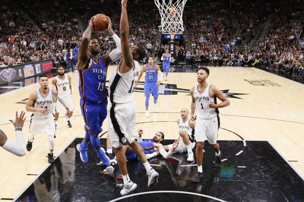 Oklahoma City Thunder small forward Paul George (13) shoots the ball as San Antonio Spurs power forward LaMarcus Aldridge (12) defends during the second half at AT&T Center. — Reuters