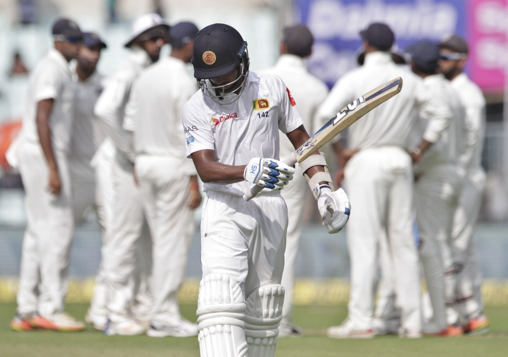 Sri Lanka's Sadeera Samarawickrama reacts as he leaves the ground after losing his wicket during the third day of their first cricket Test match against India in Kolkata, India, Saturday. — AP 
