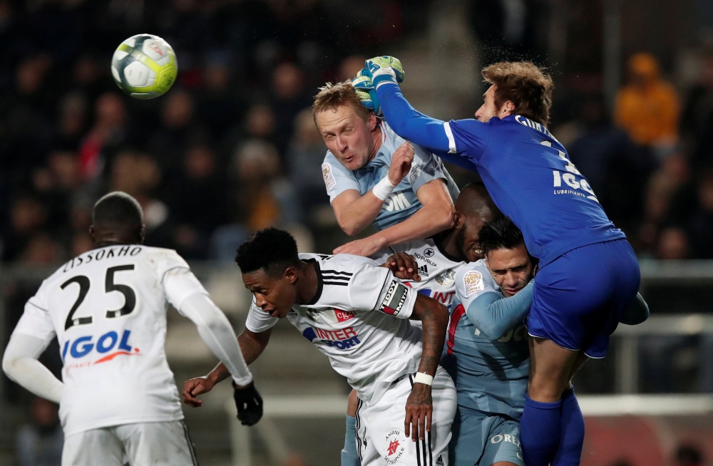 Monaco's Kamil Glik battles with Amiens’ Regis Gurtner during the French League action at the Stade de la Licorne, Amiens, France, on Friday. — Reuters
